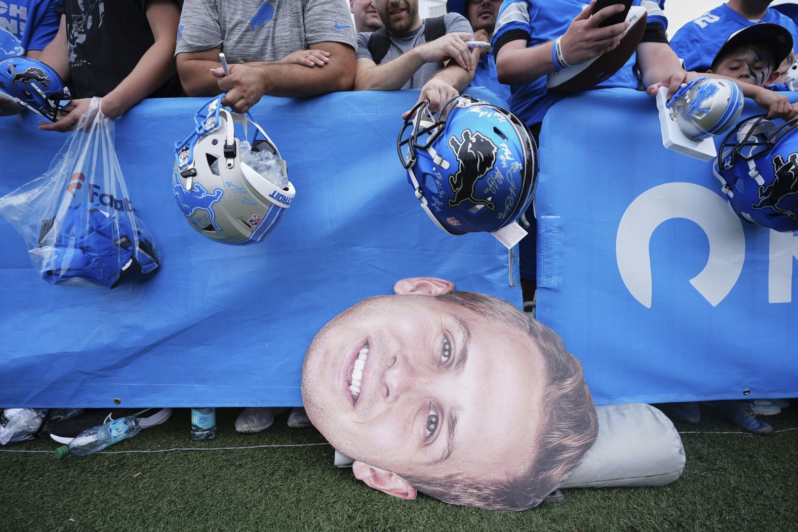 A cutout photo of Detroit Lions quarterback Jared Goff is seen on the ground as fans wait for players to sign autographs at the Lions’ training camp in Allen Park, Michigan, on Saturday, July 26.