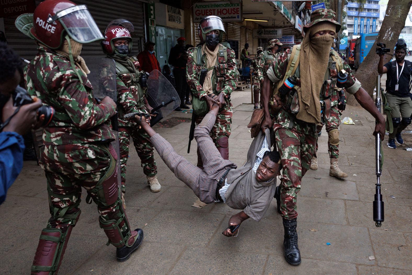 Police officers detain a suspected protester during an anti-government demonstration in Nairobi, Kenya, on Thursday, August 8.