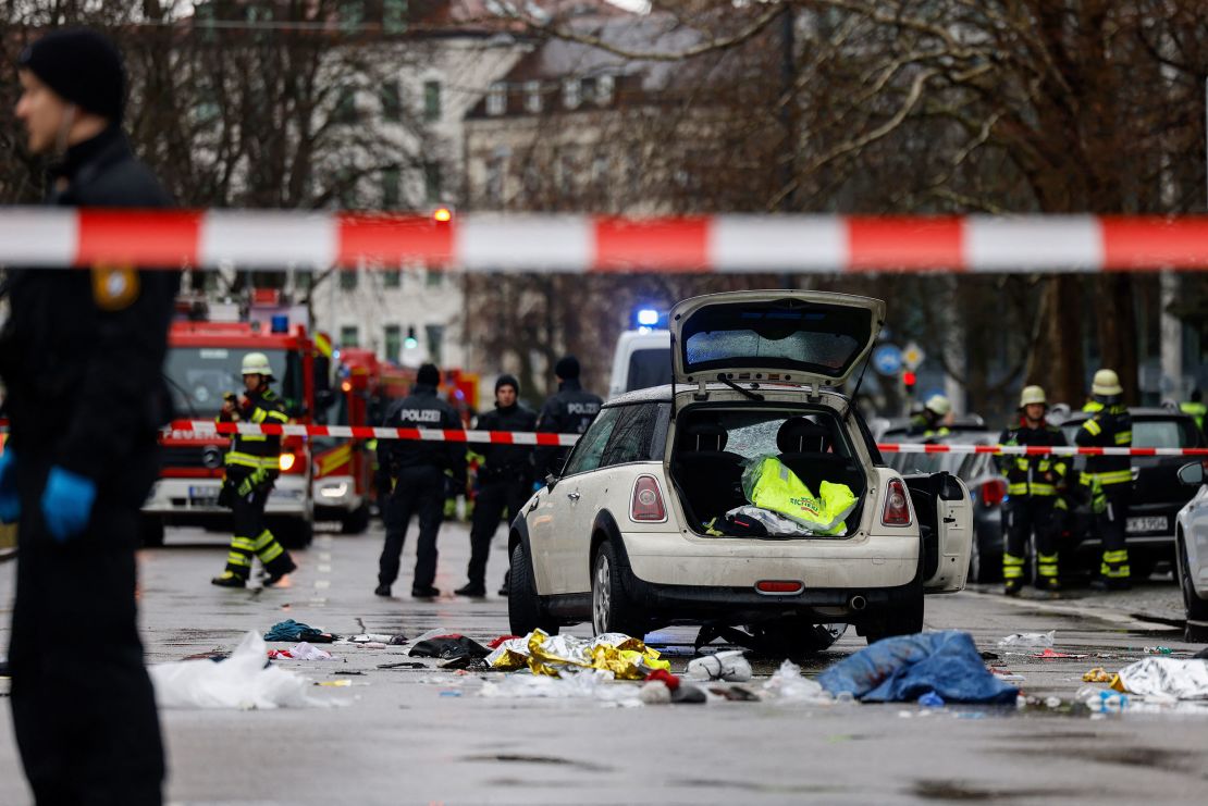 Members of the emergency services work at the scene where a car drove into a crowd in the southern German city of Munich on February 13, 2025 leaving several people injured, police said.