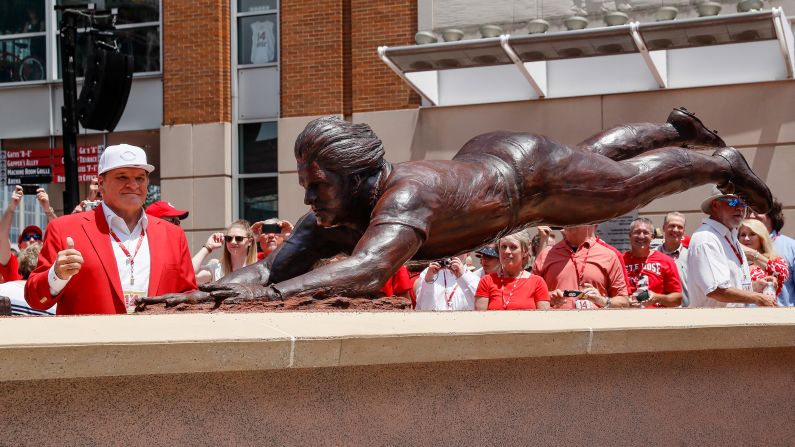 Rose stands for photos during the dedication of his statue, which was unveiled outside Cincinnati's Great American Ball Park in 2017.