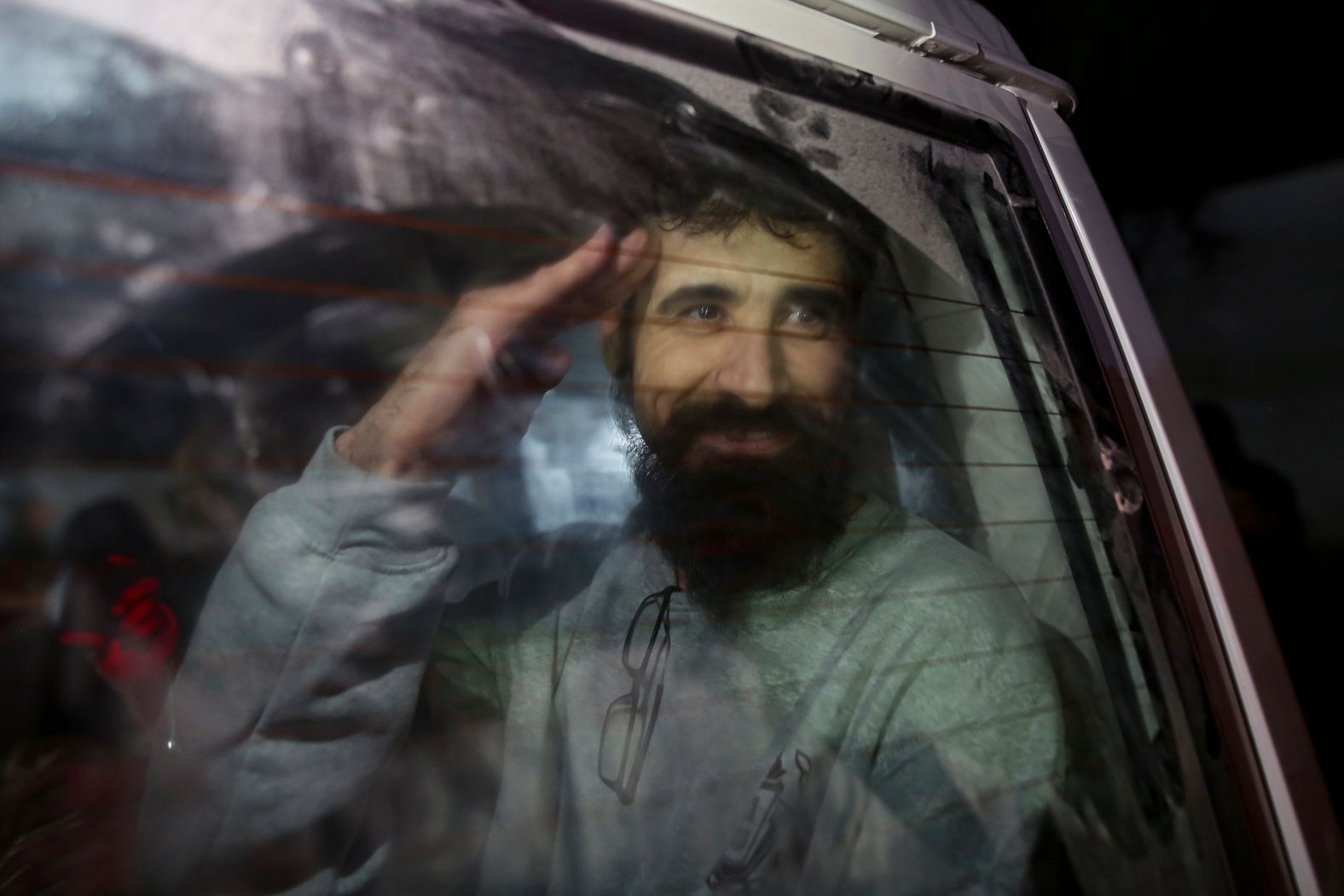 A Palestinian man waves Thursday, January 30, as he arrives in Khan Younis, Gaza, after being released from Israel as part of its ceasefire deal with Hamas. <a href="index.php?page=&url=https%3A%2F%2Fwww.cnn.com%2F2025%2F01%2F30%2Fmiddleeast%2Fisrael-gaza-hostage-release-chaos-intl-latam%2Findex.html">Israel released 110 detainees on Thursday</a> after eight hostages were released from captivity in Gaza.