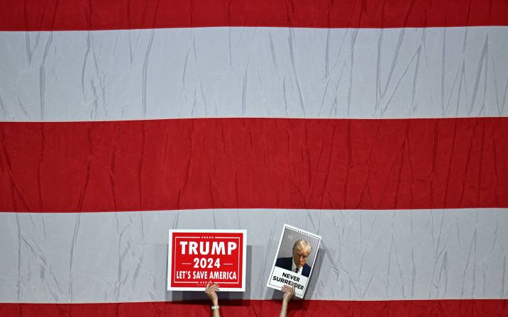 Supporters of Trump hold up placards as they wait for him to speak at a rally in Philadelphia on June 22.