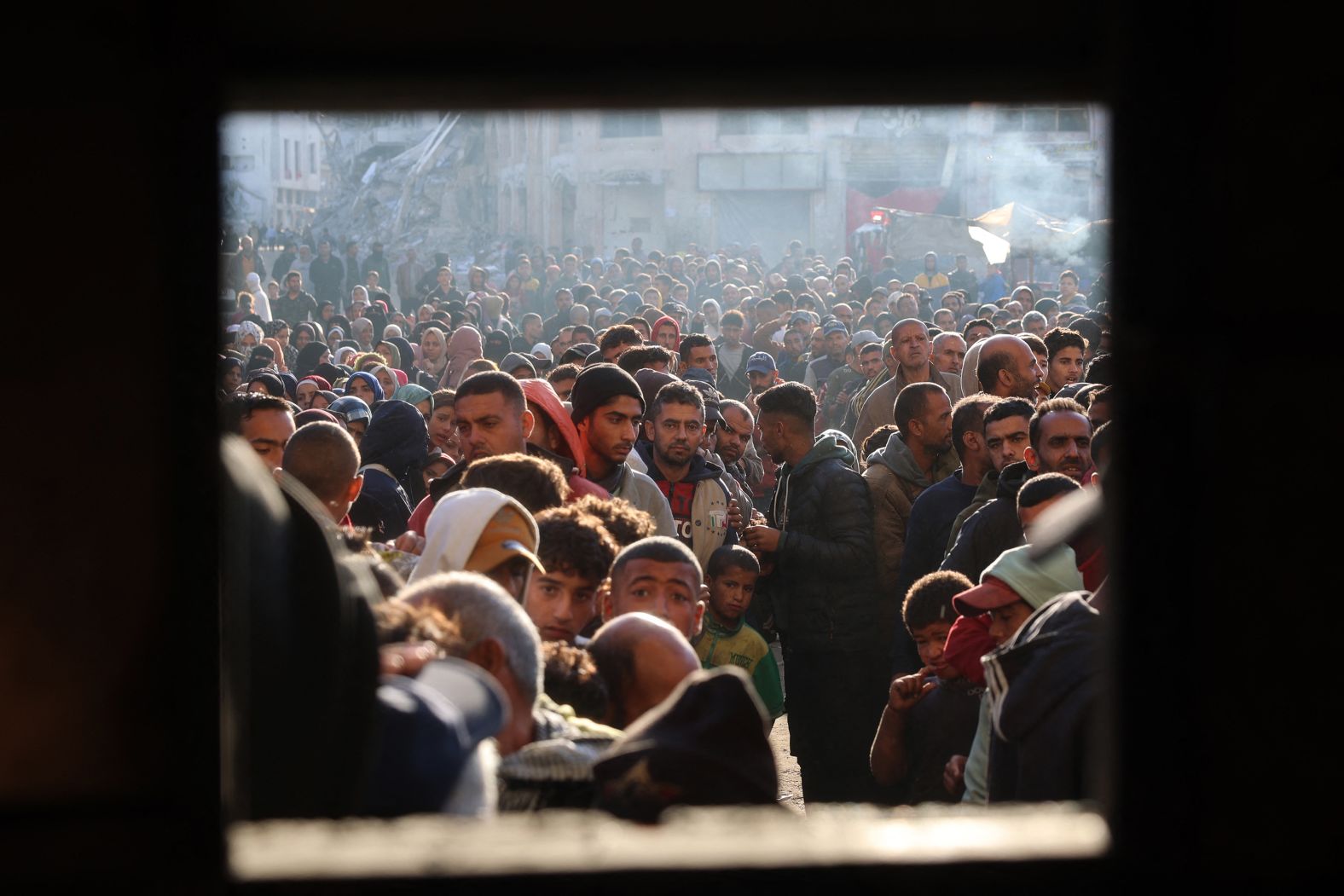 A crowd lines up for fresh bread outside a bakery in Khan Younis, Gaza, on Wednesday, November 20. <a href="index.php?page=&url=https%3A%2F%2Fwww.cnn.com%2F2024%2F10%2F11%2Fmiddleeast%2Ffood-northern-gaza-starvation-un-intl%2Findex.html">Bread remains the number one staple food for Palestinians</a> and has become a crucial basic necessity since the Israel-Hamas war started over a year ago.