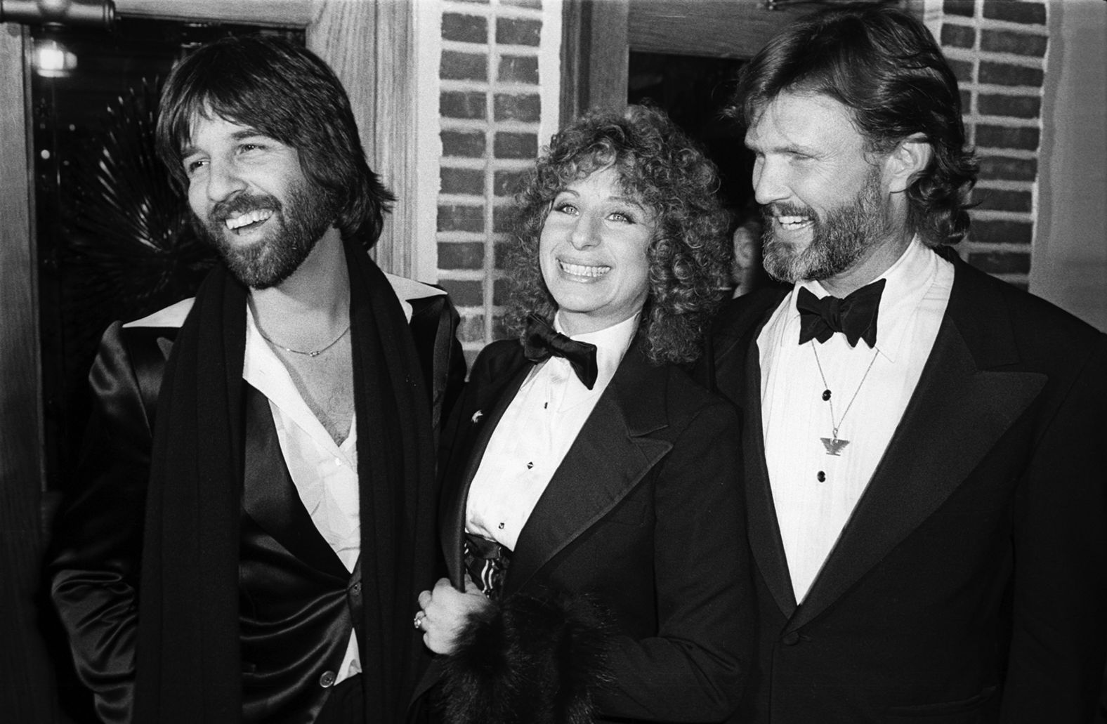Streisand attends the premiere for "A Star is Born" with producer Jon Peters, left, and co-star Kris Kristofferson.