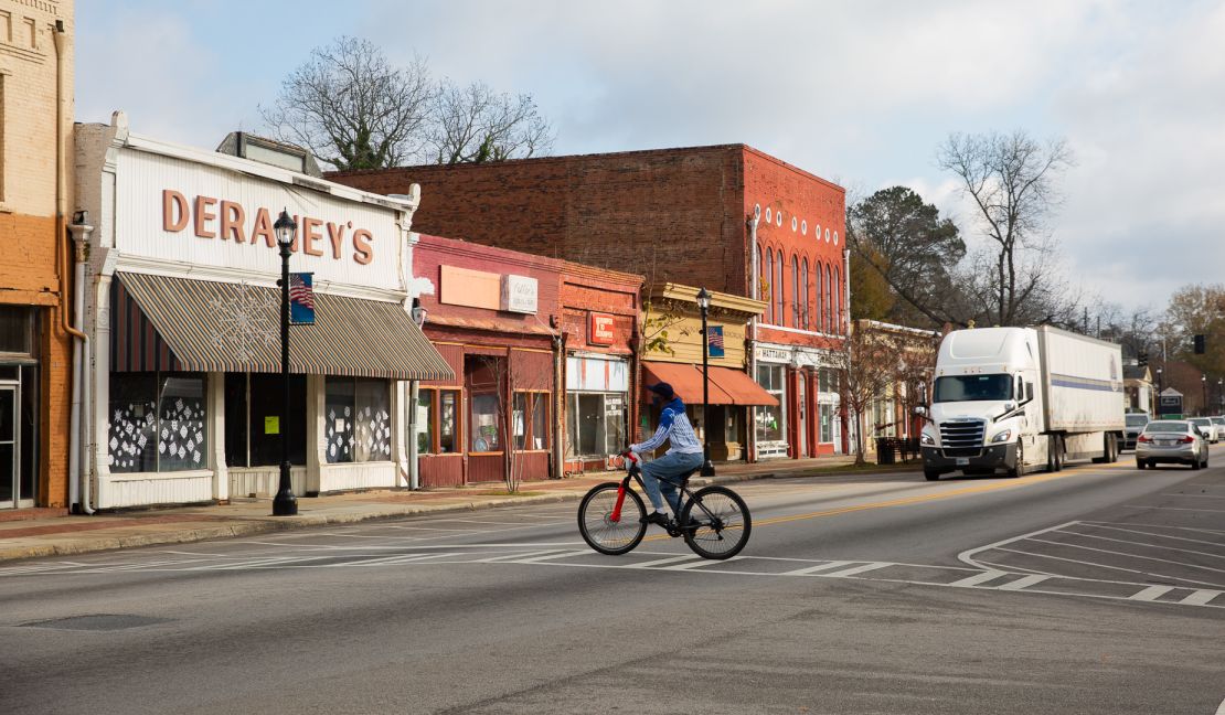 A man rides a bike through downtown Sparta last month. 