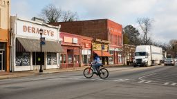 A man rides a bike through downtown Sparta, Georgia, on December 7, 2020.