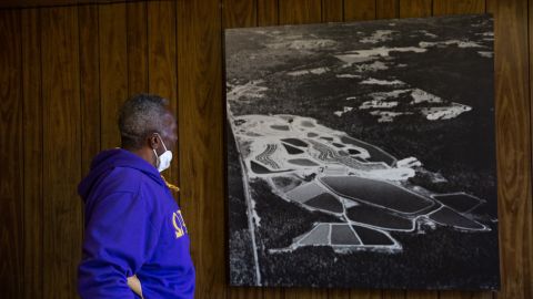 Thornton examines an old aerial photograph of his property, when it was a functioning catfish farm in Hancock County.