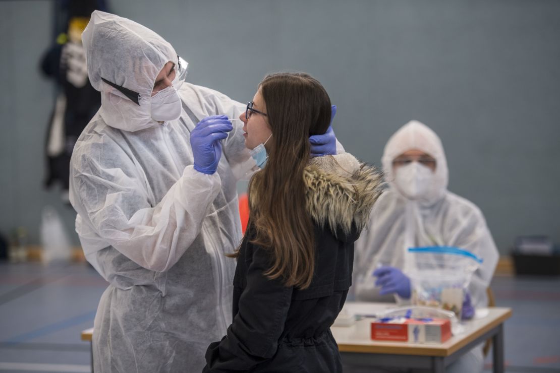 Red Cross volunteers administer a Covid-19 rapid test during a screening of students and teachers in Hildburghausen, Germany, on December 2.