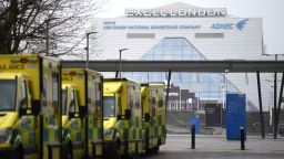 Ambulances are parked outside the NHS Nightingale hospital at the Excel centre in east London on January 1, 2021. - London's Nightingale Hospital is ready to admit patients as hospitals in the capital struggle, the NHS has said. 