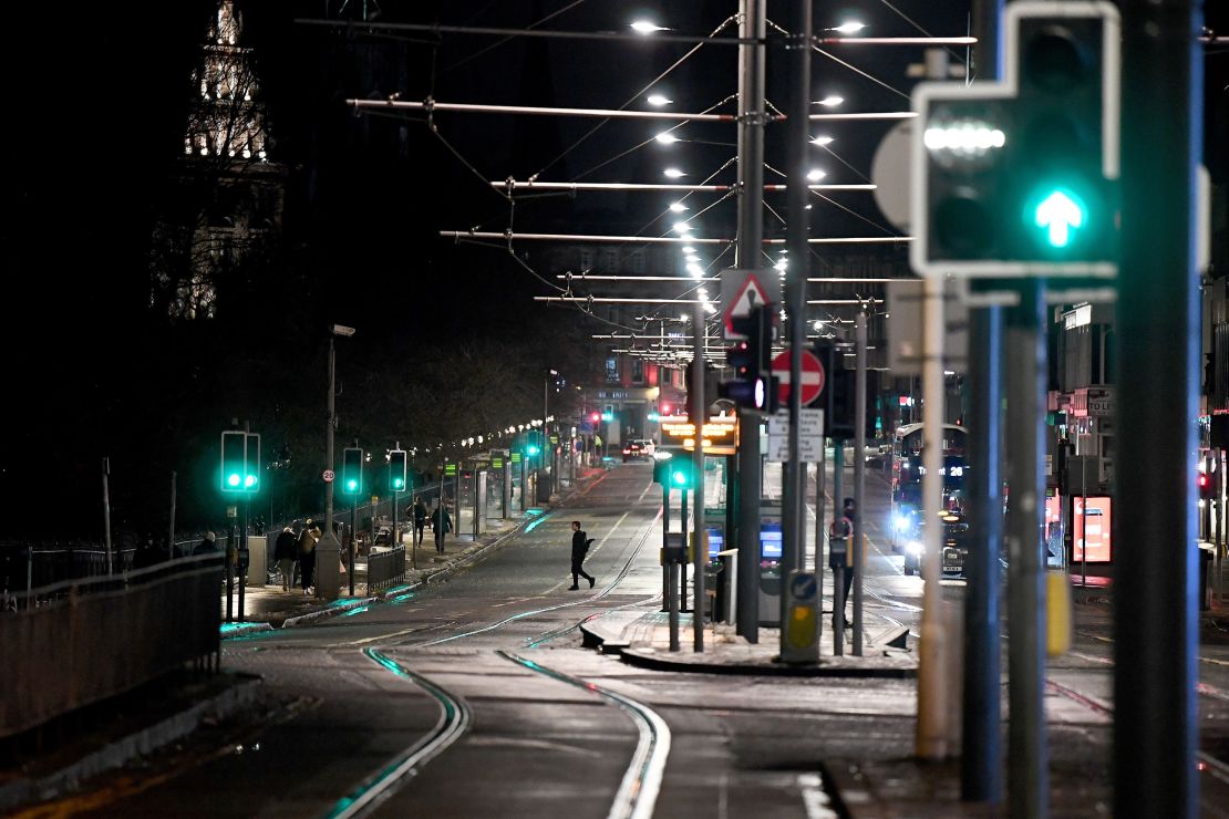 Members of the public are seen on a quiet Princess Street on Hogmanay on December 31, 2020 in Edinburgh, Scotland.