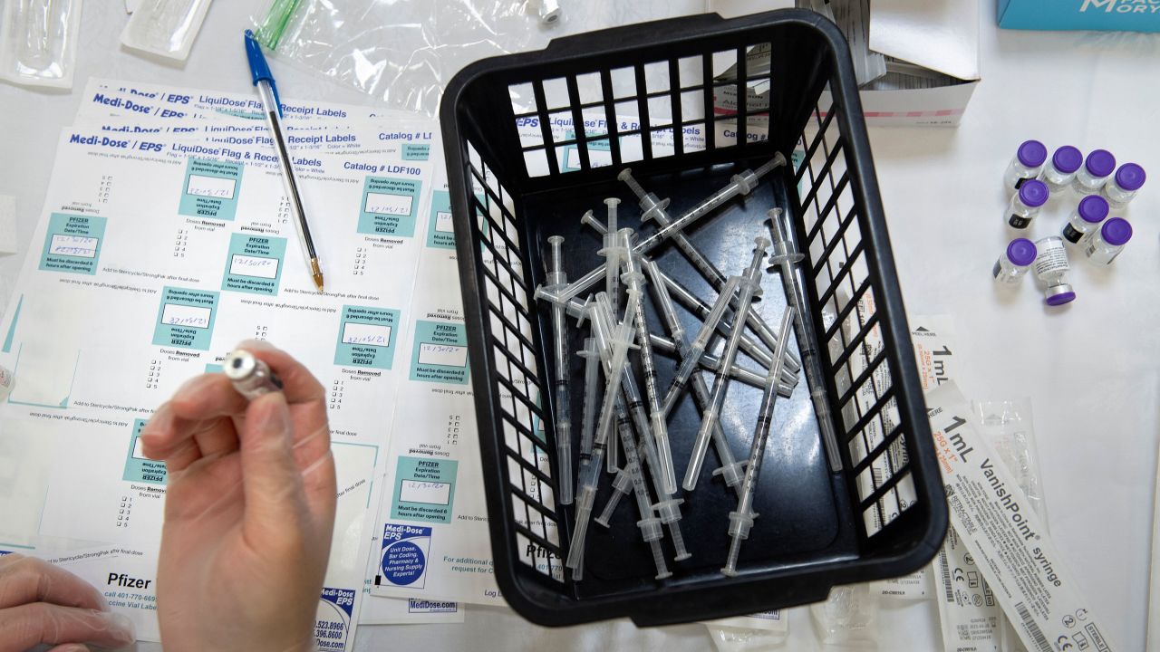 A pharmacist works to dilute the Pfizer COVID-19 vaccine while preparing it to administer to staff and residents at the Goodwin House Bailey's Crossroads, a senior living community in Falls Church, Virginia, on December 30, 2020. (Photo by Brendan Smialowski / AFP) (Photo by BRENDAN SMIALOWSKI/AFP via Getty Images)