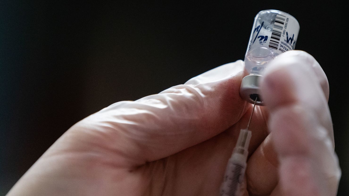 A pharmacist prepares a dose of the Pfizer-BioNTech Covid-19 vaccine on December 21, 2020, at a nursing home in New York.