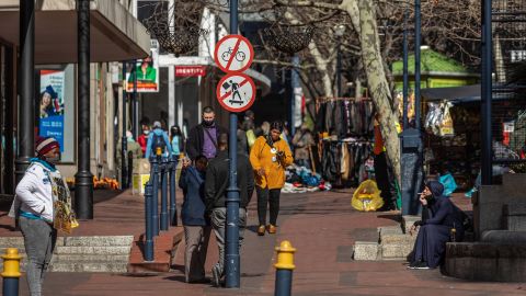 Pedestrians walk through an outdoor market area in Cape Town, South Africa, August 19.