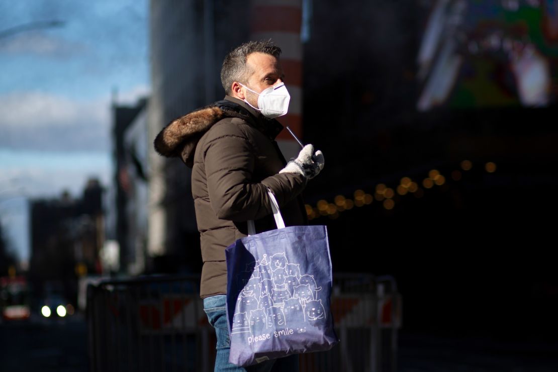 Wearing a mask in public helps protect the community from the spread of the coronavirus. A man wears a mask as he visits Times Square in New York December 10. 