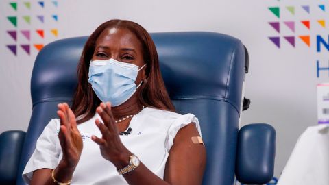 Nurse Sandra Lindsay applauds after receiving the second dose of a Pfizer coronavirus vaccine.