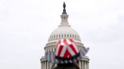 A supporter of U.S. President Donald Trump wears an American flag cowboy hat in front of the U.S. Capitol in Washington D.C., U.S. on Monday, Jan. 4, 2021. The non-stop drama of 2020 is bleeding into the first week of the new year, with a pivotal election in Georgia, promises of protests in the streets and President Trump's dragged-out fight over the November vote threatening to tear apart the Republican Party. Photographer: Stefani Reynolds/Bloomberg via Getty Images