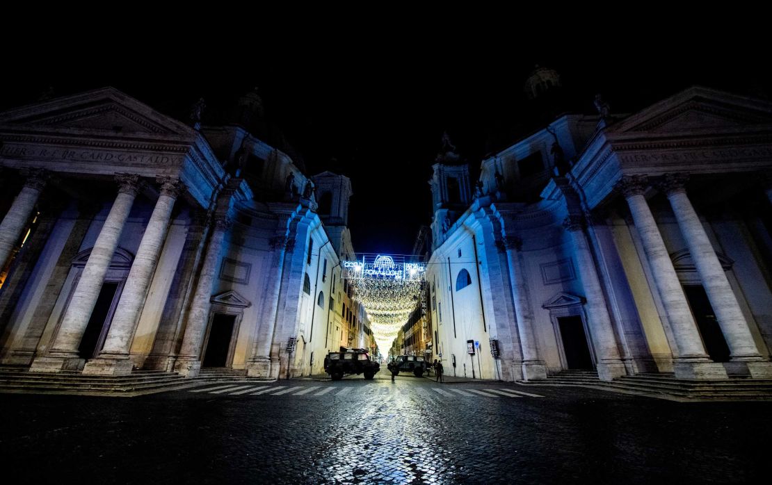 Military vehicles patrol on Piazza del Popolo in central Rome on December 31, 2020.