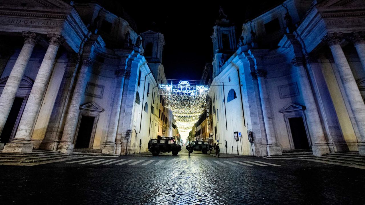 Military vehicles patrol on Piazza del Popolo in central Rome on December 31, 2020.