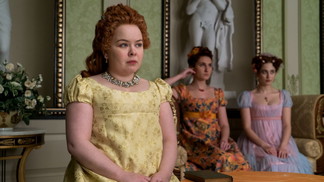 Nicola Coughlan as Penelope Featherington, Bessie Carter as Prudence Featherington and Harriet Cains as Philipa Featherington are shown in a scene from "Bridgerton."