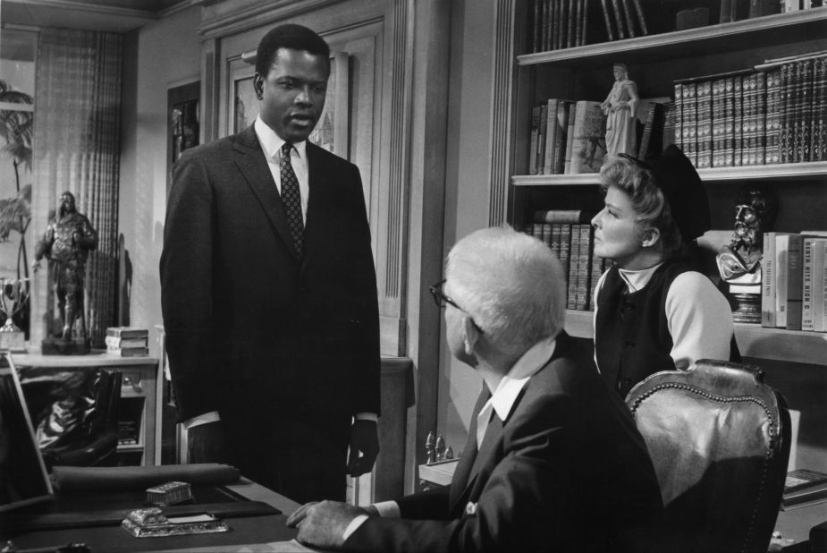 Poitier talks with Spencer Tracy and Katharine Hepburn in a scene from another 1967 hit, "Guess Who's Coming to Dinner."
