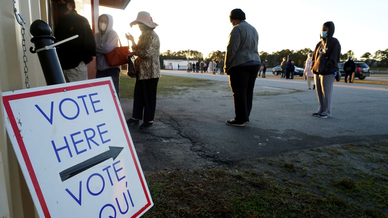 Voters stand in line to cast their ballots during the first day of early voting in the US Senate runoff at the Gwinnett Fairgrounds, December 14, 2020, in Atlanta, Georgia. - Six weeks after the contentious US presidential election, early in-person voting began Monday in Georgia ahead of a new fateful political moment: twin runoff races that will determine the balance of power in the Senate.
The southeastern state's highly-anticipated January 5 runoffs have garnered national attention as the outcome will help determine how much of President-elect Joe Biden's ambitious political agenda can get through Congress and into law. (Photo by Tami Chappell / AFP) (Photo by TAMI CHAPPELL/AFP via Getty Images)