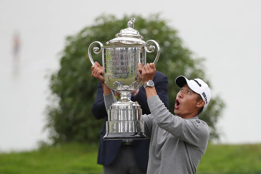 Morikawa reacts as the lid to the Wanamaker Trophy falls off during the trophy presentation for the  2020 PGA Championship.