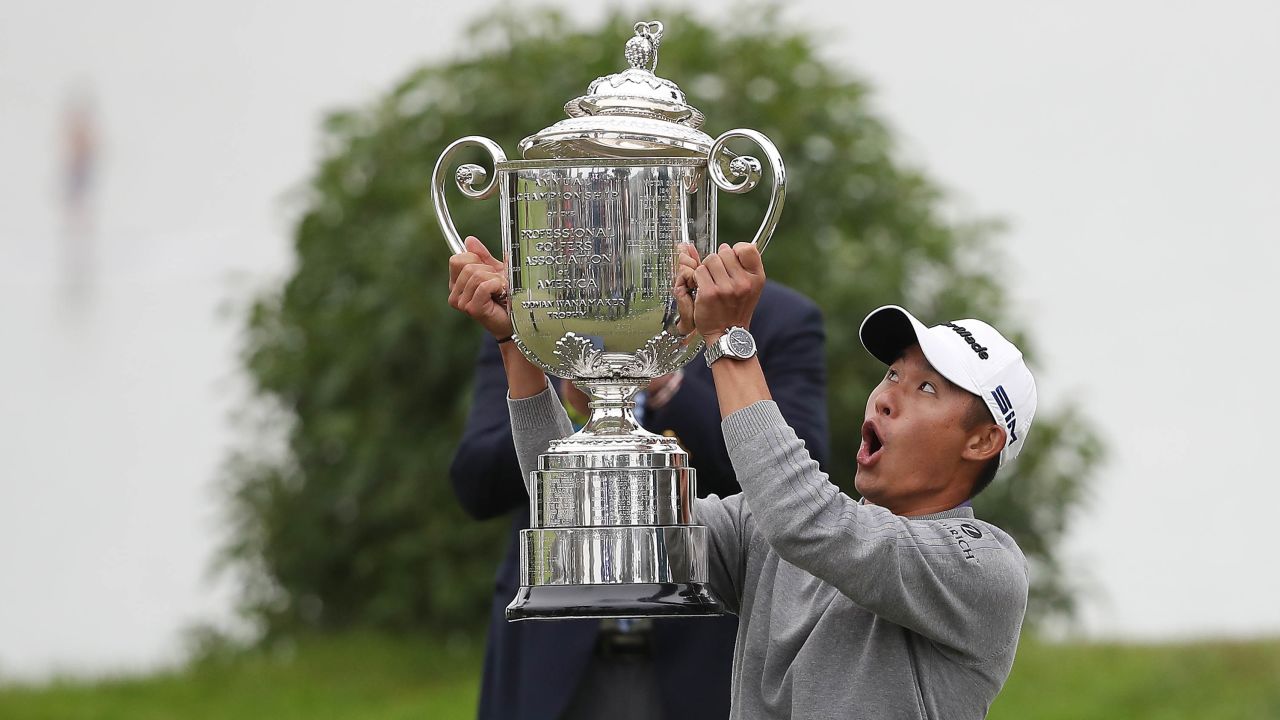 Morikawa reacts as the lid to the Wanamaker Trophy falls off during the trophy presentation for the  2020 PGA Championship.