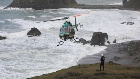 The Sonoma County Sheriff's helicopter team searches Monday for two children who were swept away in the surf near Jenner, California.