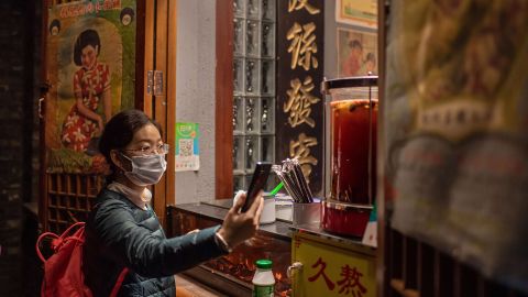 This picture taken in October shows a customer using Alipay to scan a QR payment code to make an electronic payment for a beverage at a shop in Beijing.