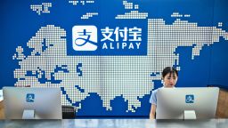 An employee works on a computer at the Alipay reception of the Shanghai office building of Ant Group in Shanghai, on August 28, 2020. (Photo by Hector RETAMAL / AFP) (Photo by HECTOR RETAMAL/AFP via Getty Images)