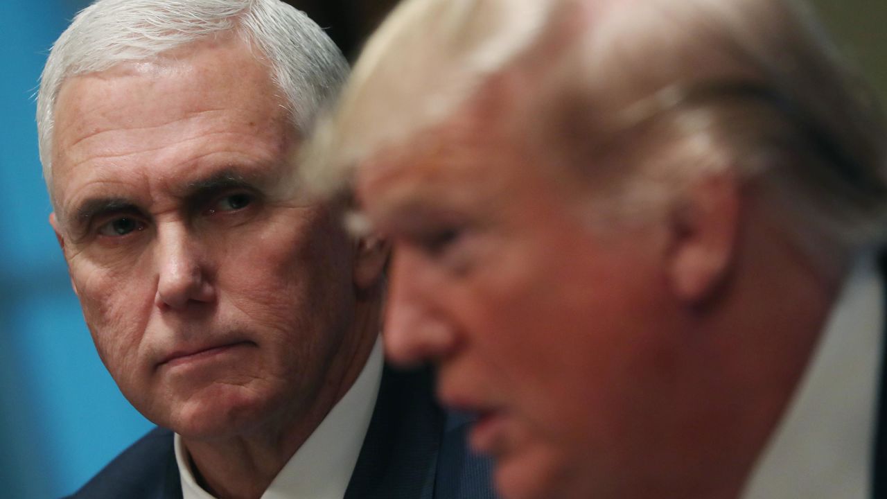 U.S. Vice President Mike Pence listens to U.S President Donald Trump (R) speak about a report released by Justice Department Inspector General Michael Horowitz on how the Justice Department and FBI launched their investigation into the 2016 campaign, During a roundtable meeting on empowering families with education choice, in the Cabinet Room on December 9, 2019 in Washington, DC.