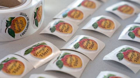 In this January 5, 2021, file photo, stickers for people who have voted sit on a table at a Cobb County voting location in Atlanta.
