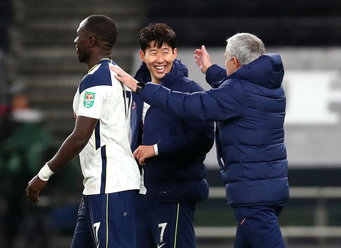 Jose Mourinho celebrates with Tottenham's two goalscorers at the final whistle.