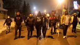 Justin Blake, uncle of Jacob Blake a black man left paralyzed after being shot by a Kenosha Police officer on August 23, 2020, center, leads a march after it was announced no charges will be filed in the case in Kenosha, Wisconsin, U.S. January 5, 2021.  REUTERS/Daniel Acker