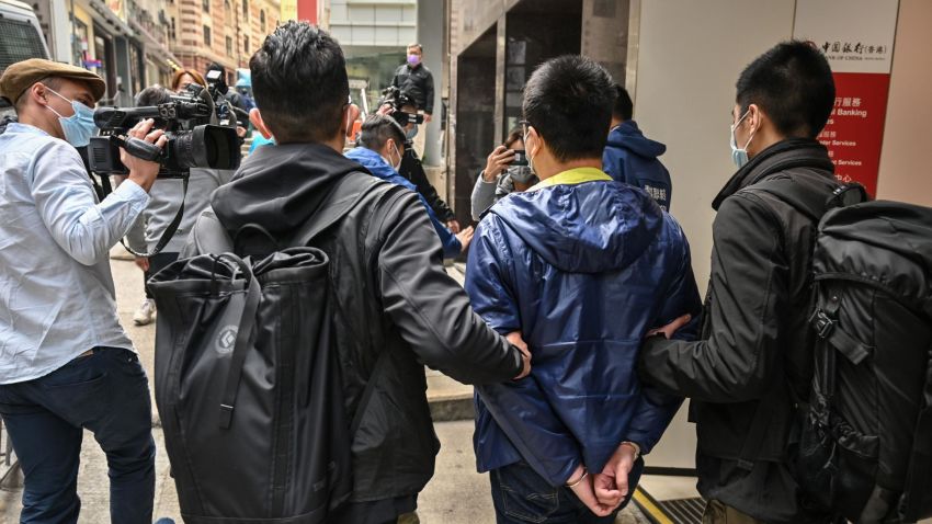 Ben Chung (2nd R) of a pro-democracy political group is arrested by police in the Central district after as many as 50 Hong Kong opposition figures were arrested in Hong Kong on January 6, 2021, under a new national security law in the largest operation yet against Beijing's critics, deepening a crackdown sweeping the financial hub. (Photo by Peter PARKS / AFP) (Photo by PETER PARKS/AFP via Getty Images)