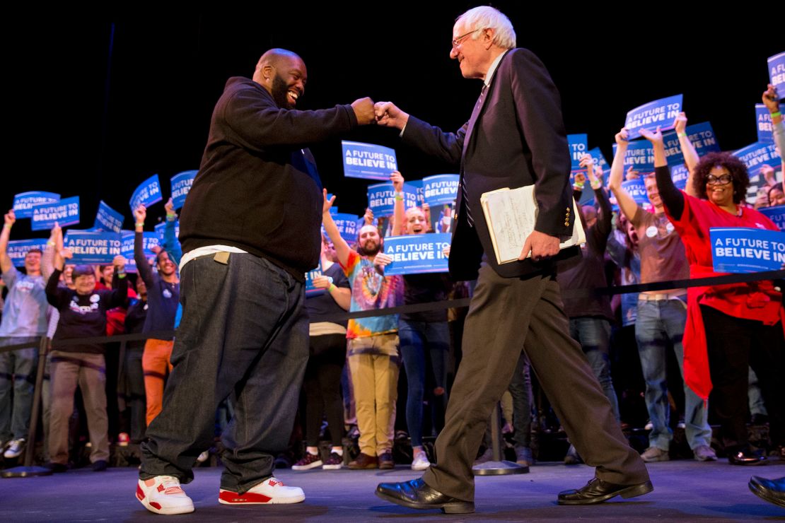 Rapper Killer Mike and Democratic presidential candidate Sen. Bernie Sanders, I-Vt., fist bump at the start of a campaign rally in Columbia, S.C., Friday, Feb. 26, 2016, the day before the South Carolina Democratic Primary. 