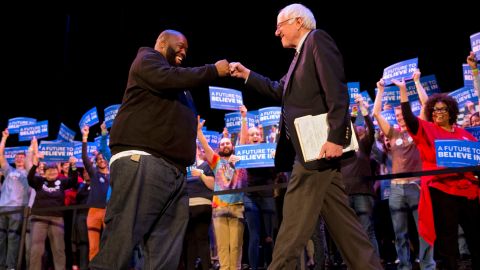 Rapper Killer Mike and Democratic presidential candidate Sen. Bernie Sanders, I-Vt., fist bump at the start of a campaign rally in Columbia, S.C., Friday, Feb. 26, 2016, the day before the South Carolina Democratic Primary. 