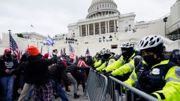 Trump supporters try to break through a police barrier, Wednesday, Jan. 6, 2021, at the Capitol in Washington. As Congress prepares to affirm President-elect Joe Biden's victory, thousands of people have gathered to show their support for President Donald Trump and his claims of election fraud. (AP Photo/John Minchillo)