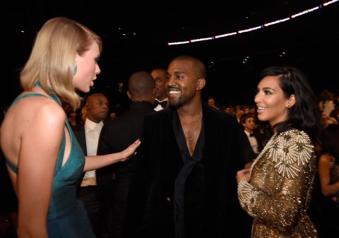 Singer Taylor Swift talks to Kanye at the Grammy Awards in February 2015.