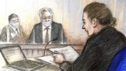Court artist sketch by Elizabeth Cook showing Julian Assange, centre, appearing at Westminster Magistrates' Court where the WikiLeaks founder was refused bail, in London, Wednesday Jan. 6, 2021.  The United States authorities are appealing against a recent court decision to block the extradition of Assange, and WikiLeaks said Wednesday the denial of bail would be appealed. (Elizabeth Cook/PA via AP)