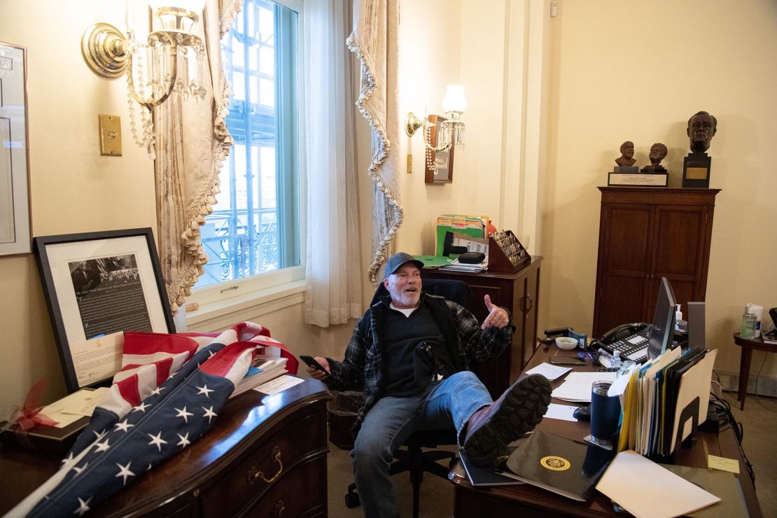Richard "Bigo" Barnett sits inside House Speaker Nancy Pelosi's office on January 6.