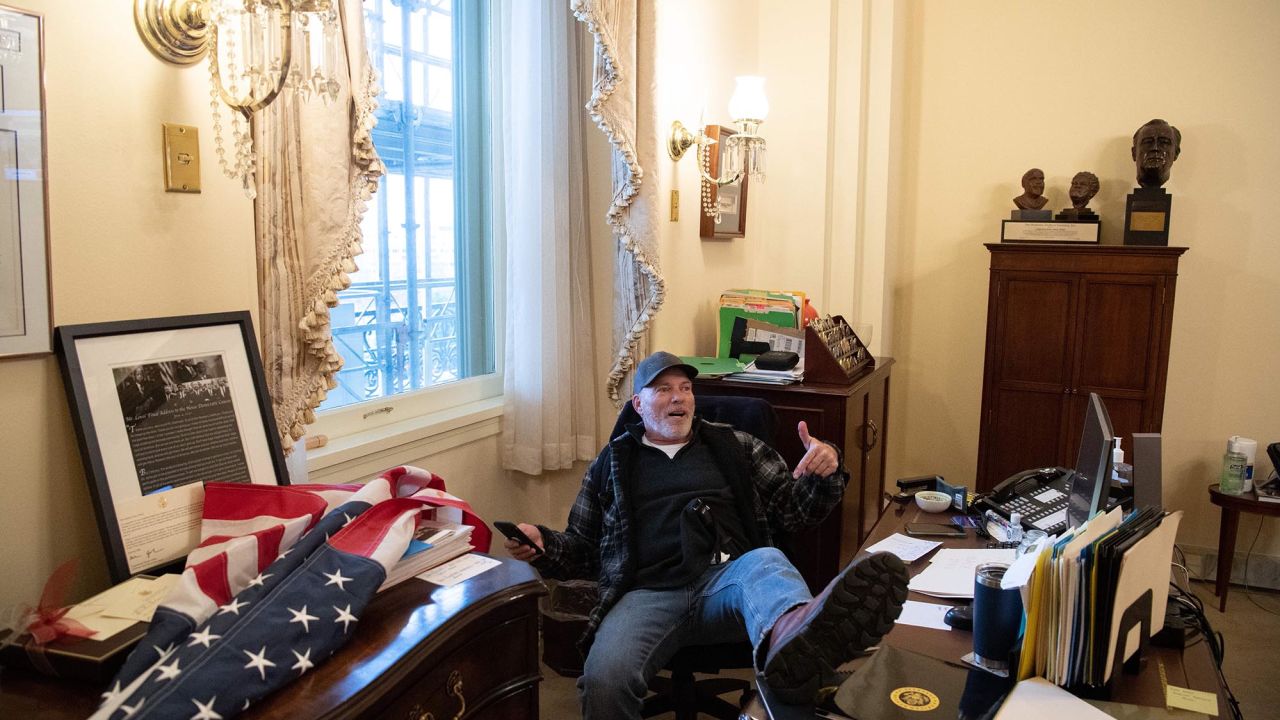 Richard "Bigo" Barnett sits inside House Speaker Nancy Pelosi's office on January 6.