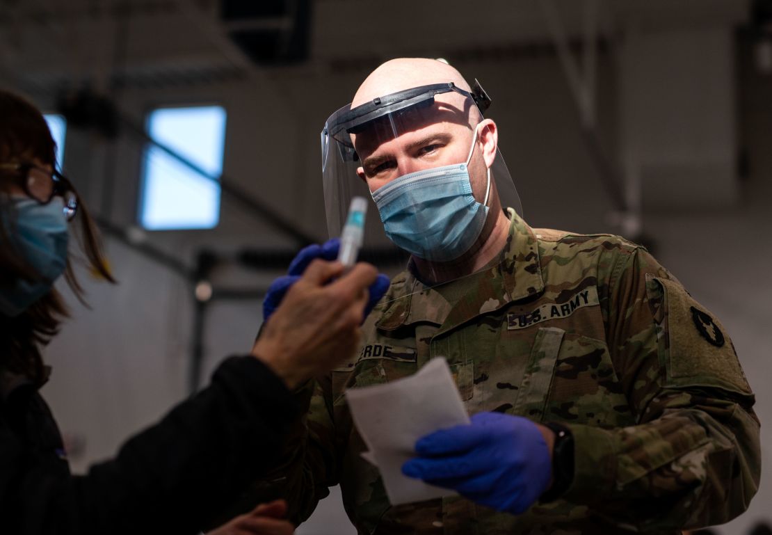 Minnesota National Guard Lt. Daniel Jerde assists a woman with her test at a Covid-19 testing facility in Stillwater, Minnesota, on December 10.