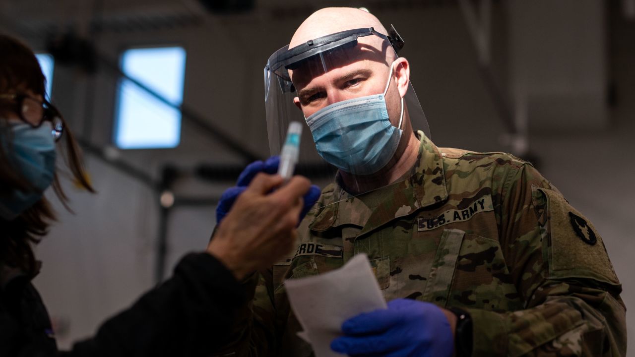 Minnesota National Guard Lt. Daniel Jerde assists a woman with her test at a Covid-19 testing facility in Stillwater, Minnesota, on December 10.