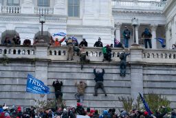 Supporters of President Donald Trump climb the west wall of the the U.S. Capitol on Wednesday, Jan. 6, 2021, in Washington. (AP Photo/Jose Luis Magana)