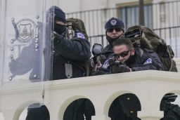 Police keep a watch on demonstrators who tried to break through a police barrier, Wednesday, Jan. 6, 2021, at the Capitol in Washington. As Congress prepares to affirm President-elect Joe Biden's victory, thousands of people have gathered to show their support for President Donald Trump and his claims of election fraud.(AP Photo/John Minchillo)