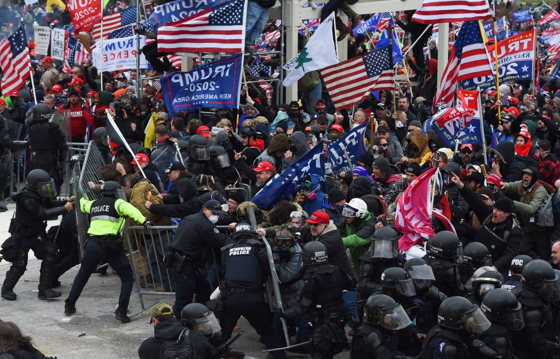 Trump supporters clash with police and security forces as they push barricades to storm the US Capitol on January 6.