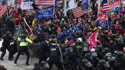 Trump supporters clash with police and security forces as they push barricades to storm the US Capitol in Washington D.C on January 6, 2021. - Demonstrators breeched security and entered the Capitol as Congress debated the a 2020 presidential election Electoral Vote Certification. (Photo by ROBERTO SCHMIDT / AFP) (Photo by ROBERTO SCHMIDT/AFP via Getty Images)