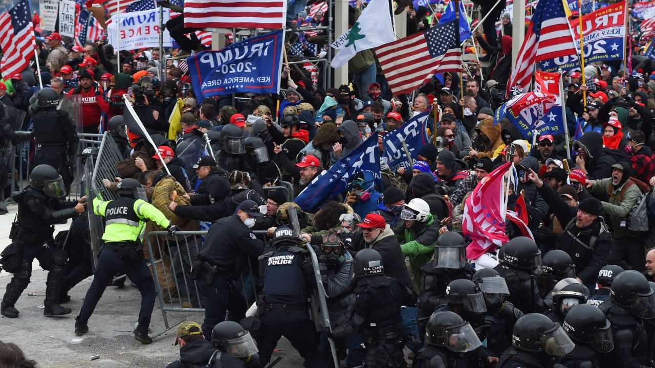 Trump supporters clash with police and security forces as they push barricades to storm the US Capitol on January 6.
