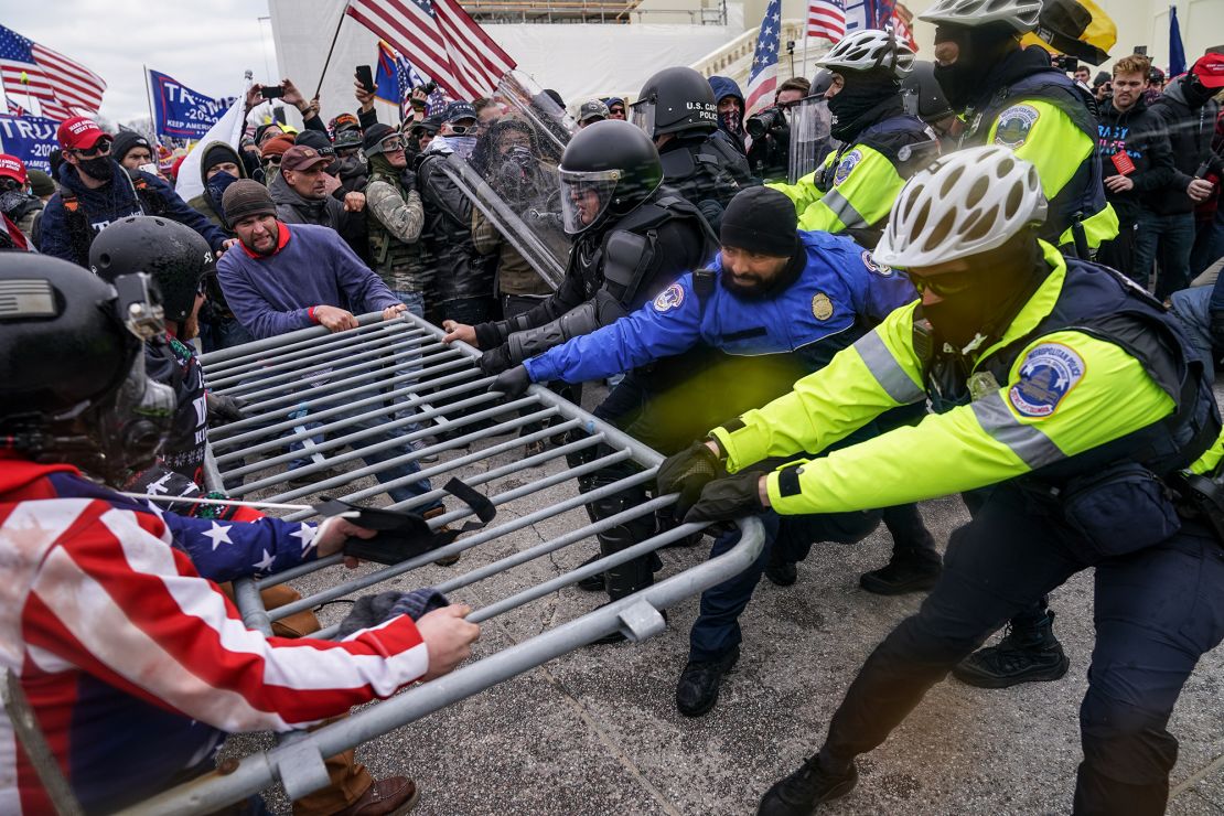 Trump supporters try to break through a police barrier on January 6 at the Capitol.